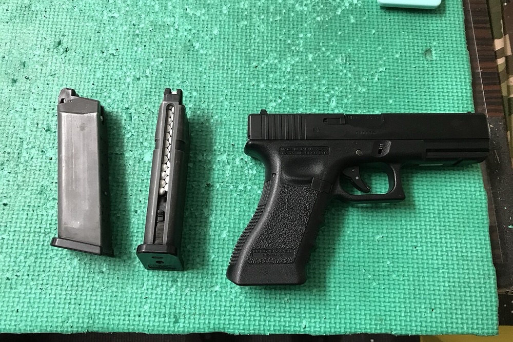 Airsoft gas blowback Glock with a BB-loaded magazine