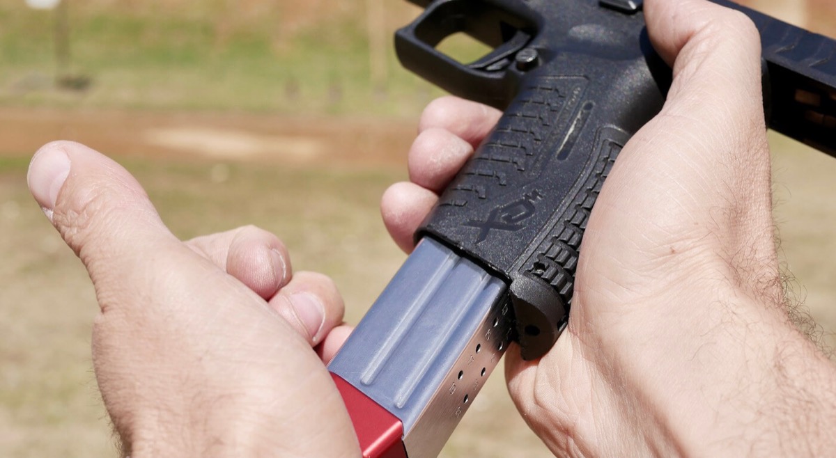 Practical pistol shooter running an IDPA stage