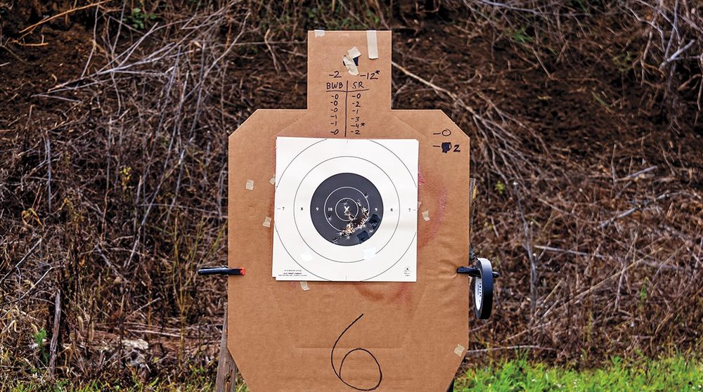 A B-8 repair center taped to the chest of a silhouette target for scoring