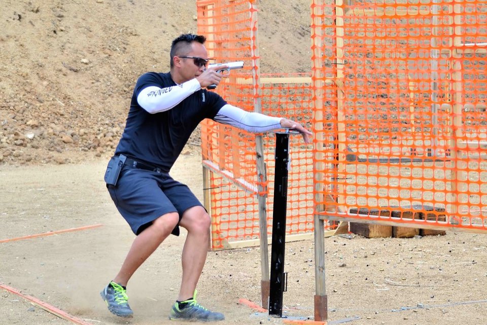 A competitor moving through a stage with the muzzle downrange