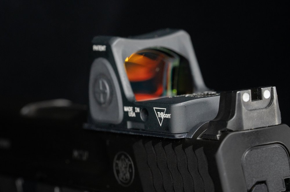 Slide-mounted red dot on a Smith & Wesson M&P 2.0 — the optic must sit on the slide, between the rear of the slide and the ejection port
